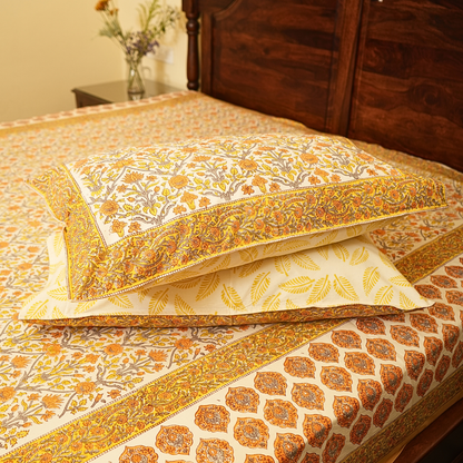 Decorative pillows with intricate patterns on a bed in a bedroom setting.