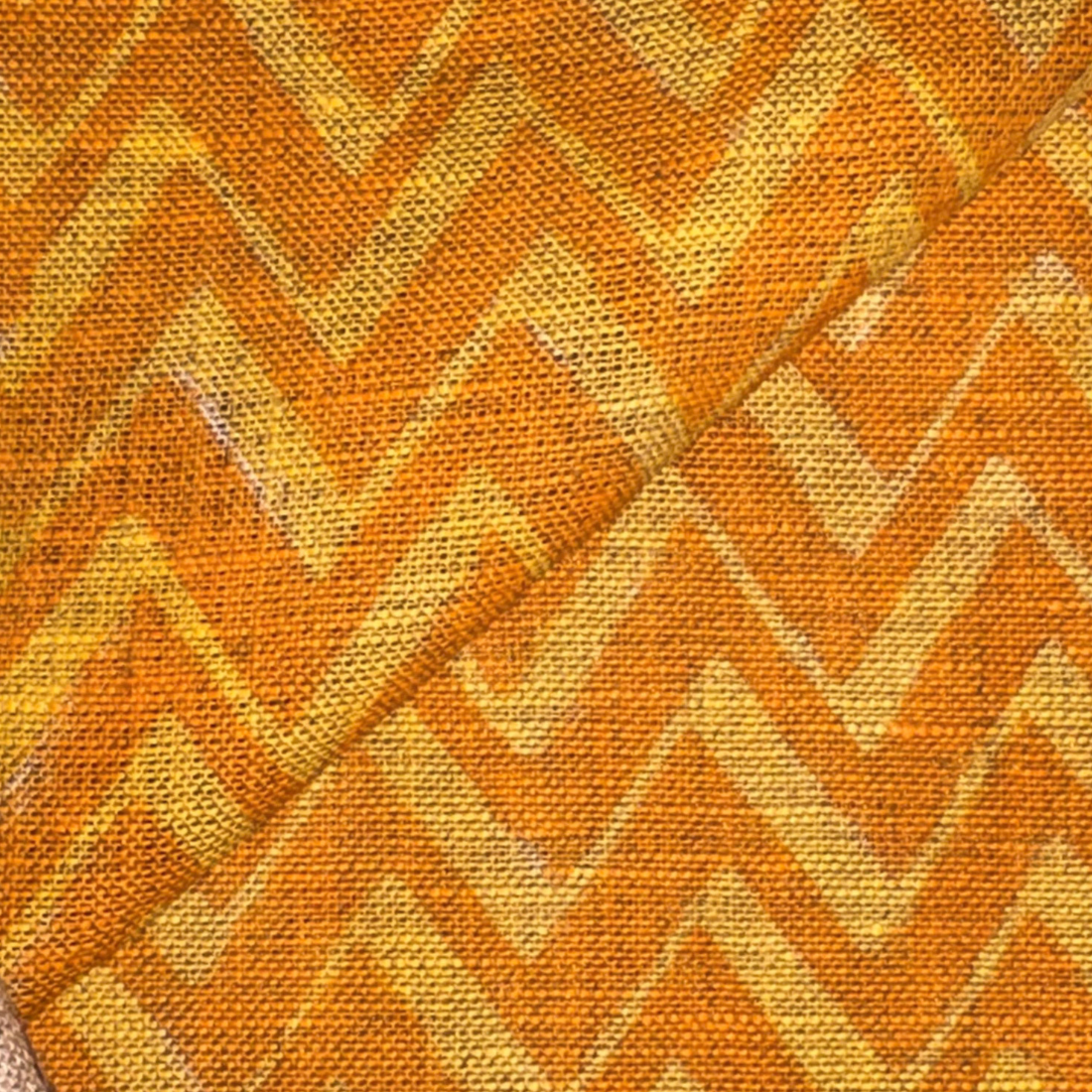 Patterned fabric with orange and yellow chevron design
