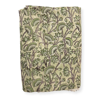 Folded fabric with green floral pattern on a white background