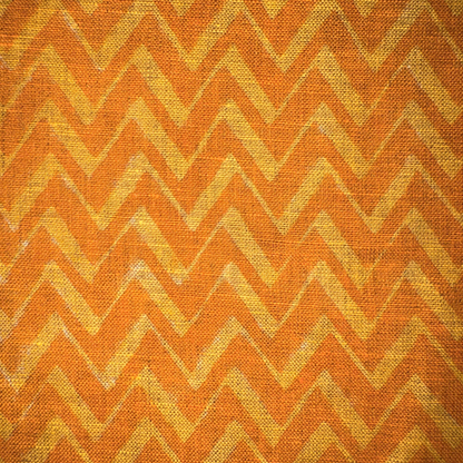 Fabric with orange and yellow chevron pattern