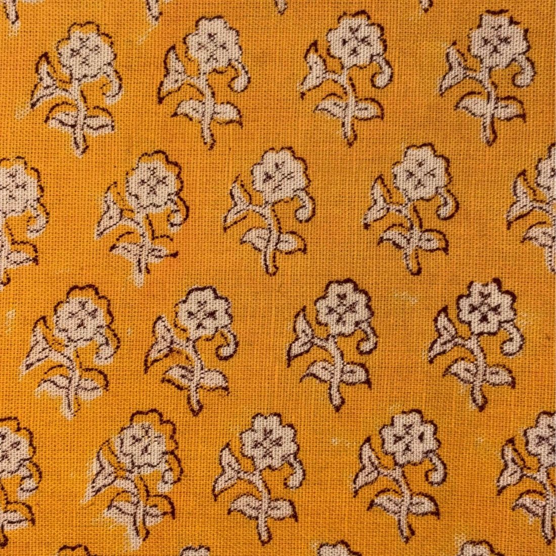 Patterned fabric with floral design on a yellow background