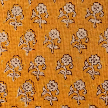 Patterned fabric with floral design on a yellow background