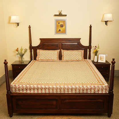 Wooden bed with floral bedding in a bedroom setting