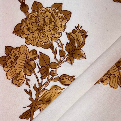 Brown floral design on a white fabric background