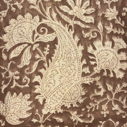 Close-up of a brown fabric with beige floral paisley pattern