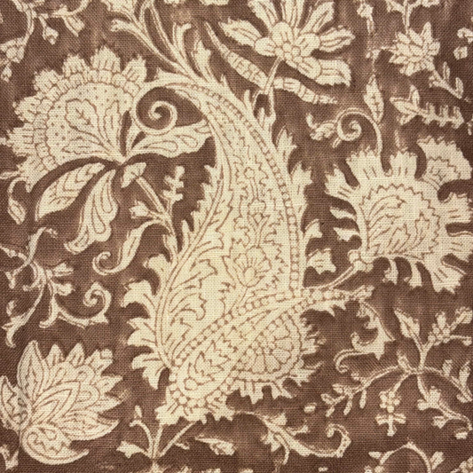 Close-up of a brown fabric with beige floral paisley pattern