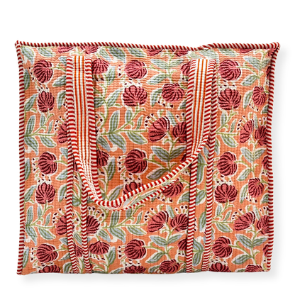 Floral patterned tote bag with red and green design on a white background