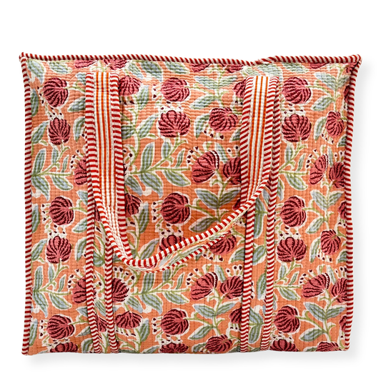Floral patterned tote bag with red and green design on a white background