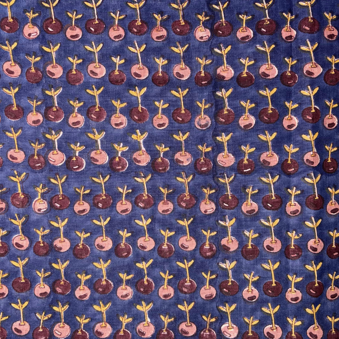 Pattern of small plants on a blue fabric background