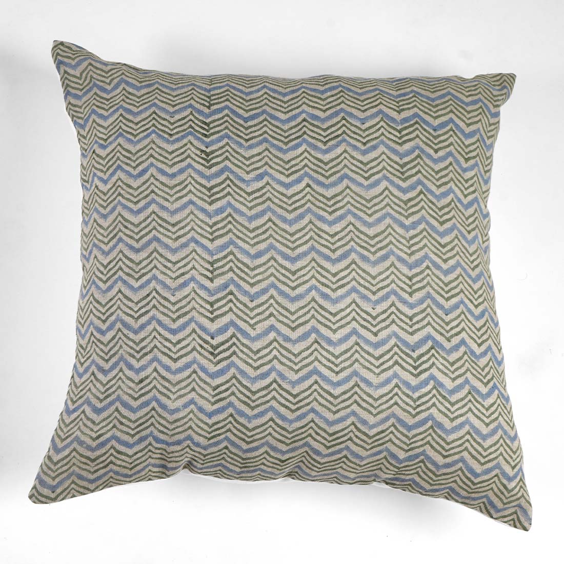 Decorative pillow with zigzag pattern on a white background