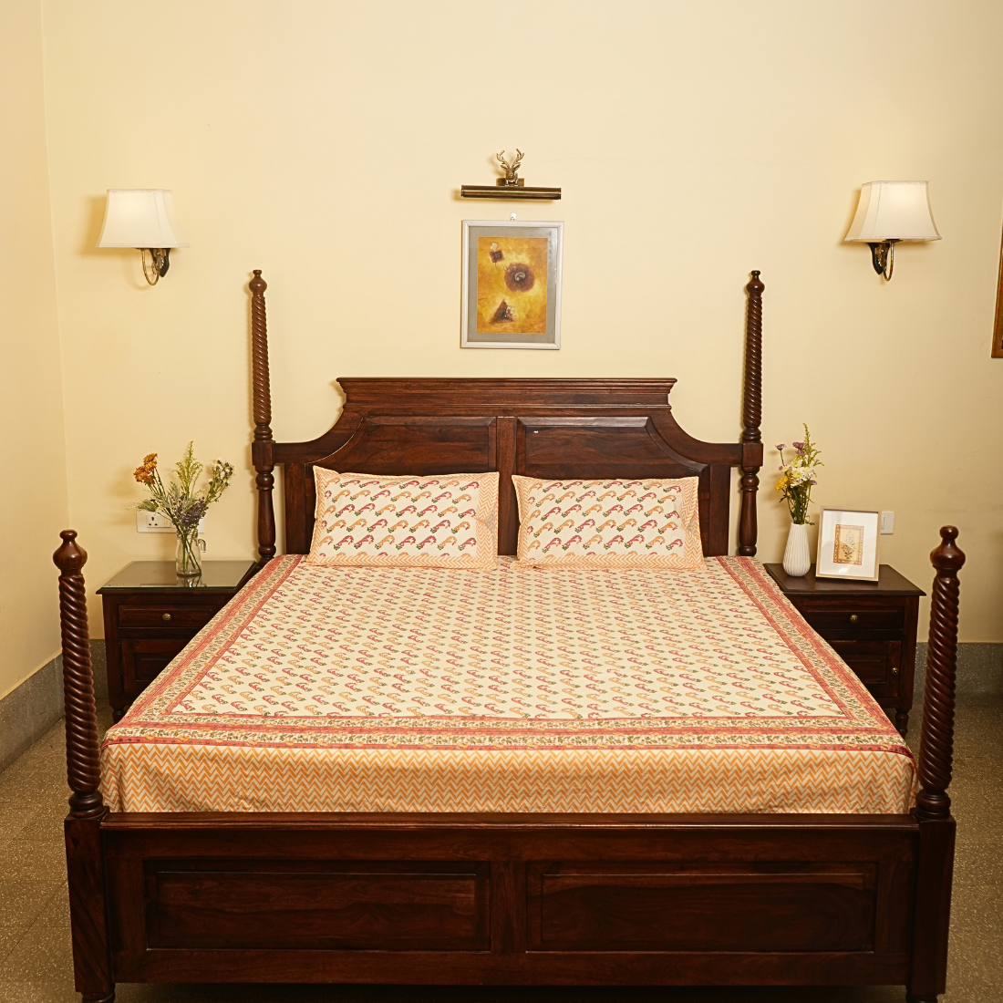 Wooden bed with patterned bedding in a bedroom setting.