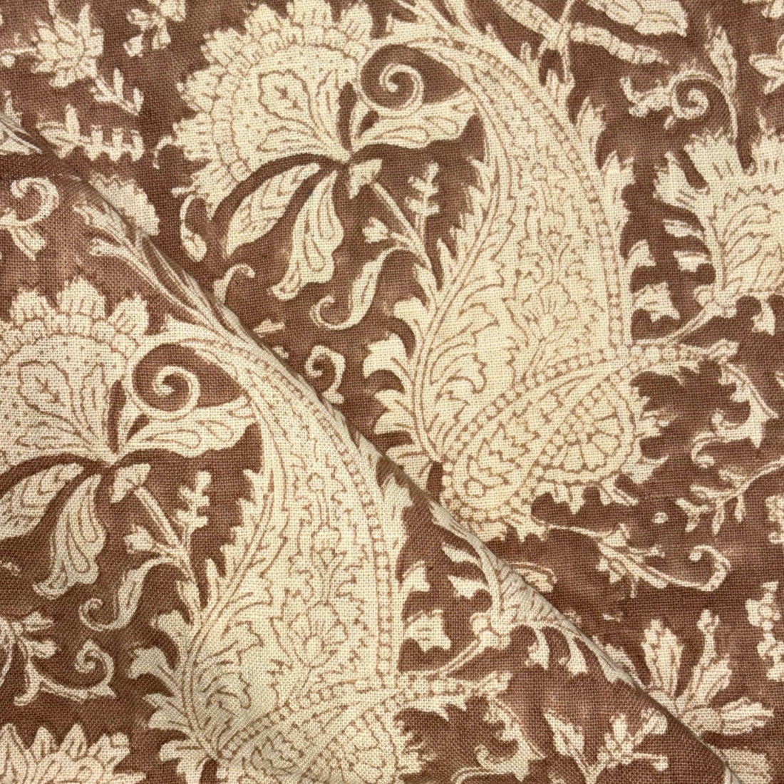 Close-up of a brown and beige paisley pattern fabric
