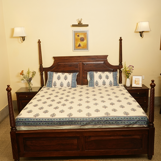 Wooden bed with floral bedding in a bedroom setting