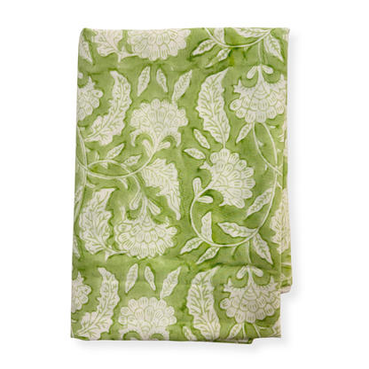 Green fabric with white floral pattern on a white background