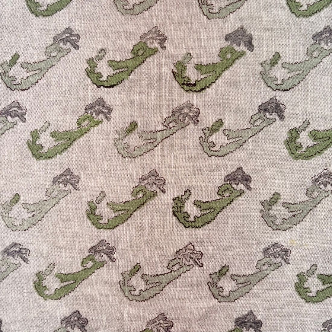 Pattern of green and purple shapes on a textured grey background