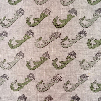 Pattern of green and purple shapes on a textured grey background
