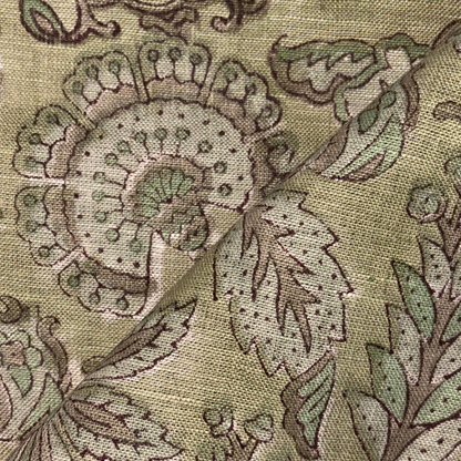Close-up of a floral patterned fabric with green and brown colors.