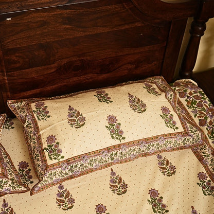 Floral-patterned pillow and bedspread on a wooden bed