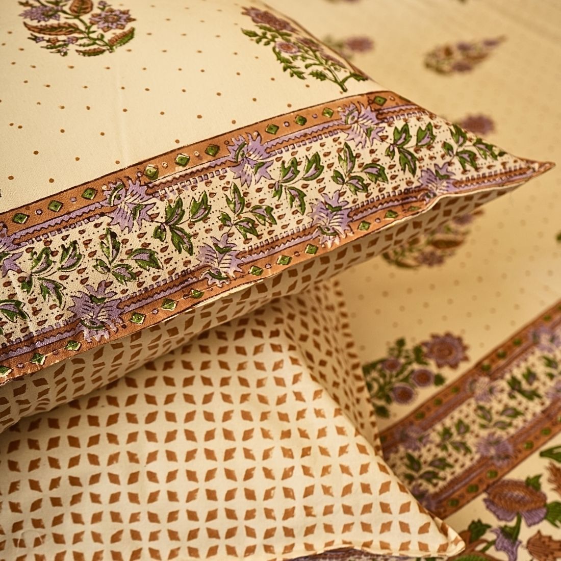 Decorative pillows with intricate patterns on a beige background