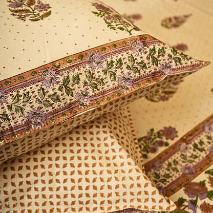 Decorative pillows with intricate patterns on a beige background