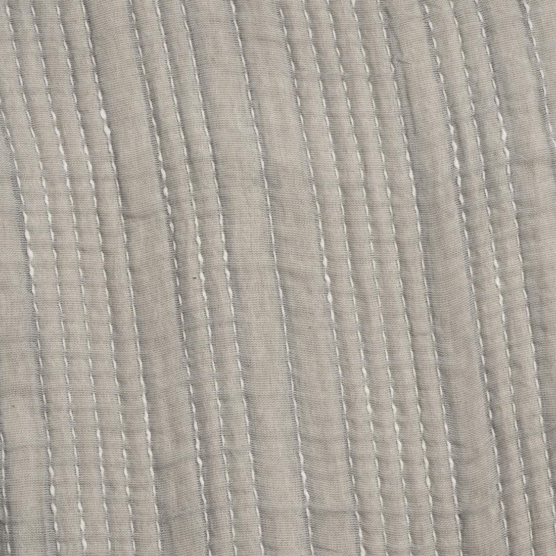 Close-up of textured gray throw with subtle pattern