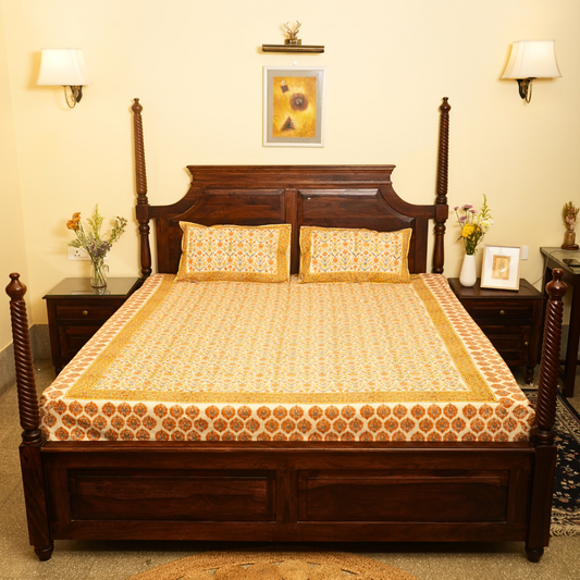 Wooden bed with floral bedding in a bedroom setting