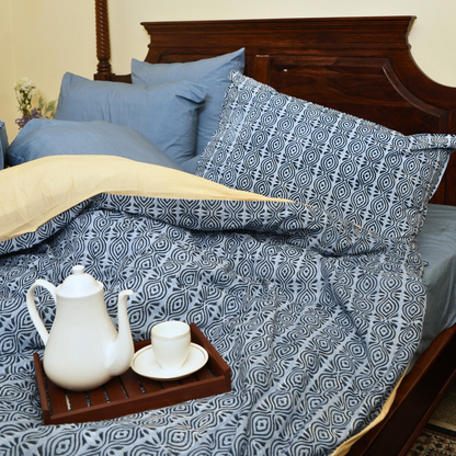 Bed with patterned bedding. 