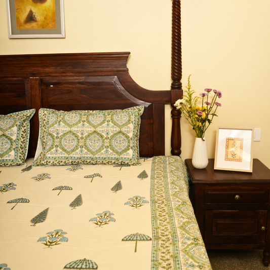 Bedroom with floral bedspread, wooden headboard, and decorative pillows.