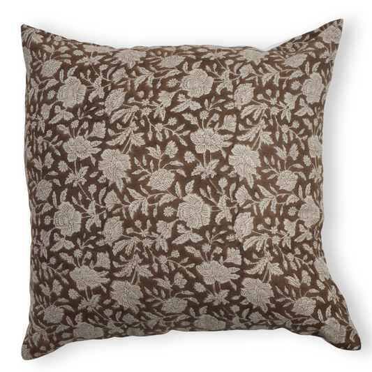 Floral patterned pillow on a brown background