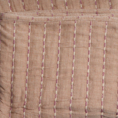 Close-up of a throw with vertical purple stripes on a brown background