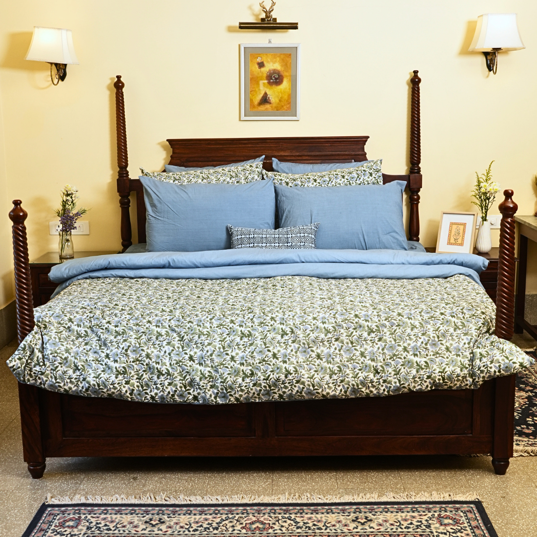 Bedroom with floral bedding, and decorative pillows.