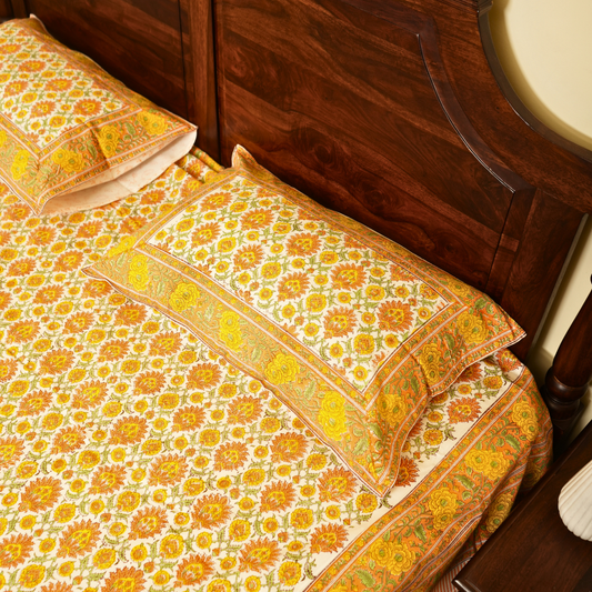 Decorative bedspread with floral pattern on a wooden bed
