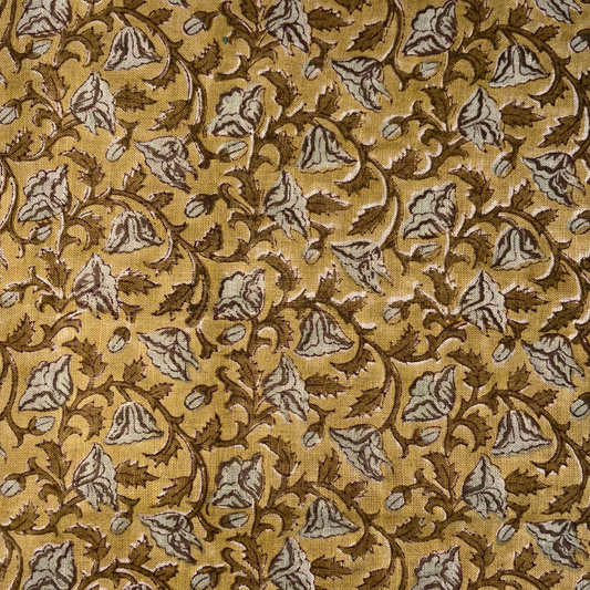 Patterned fabric with brown and beige design on a yellow background