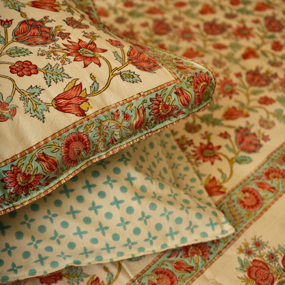 Close-up of a white fabric with green and red floral patterns