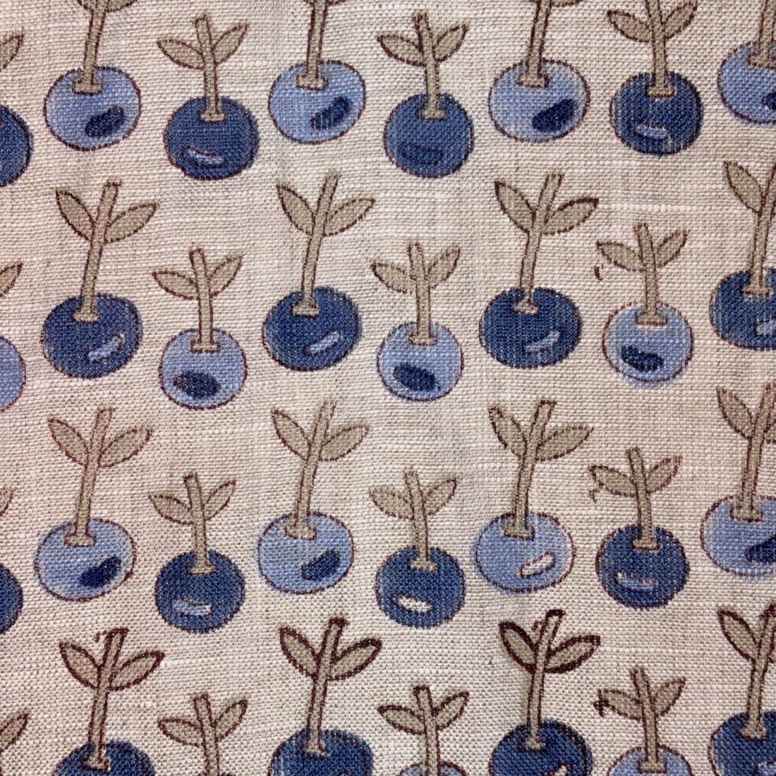 Pattern of blue berries with stems on a grey background