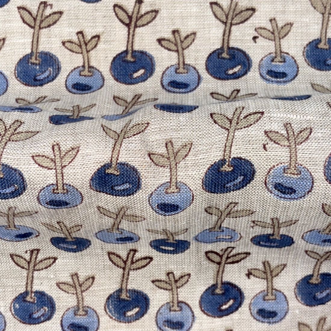 Pattern of blueberries with stems on a fabric background