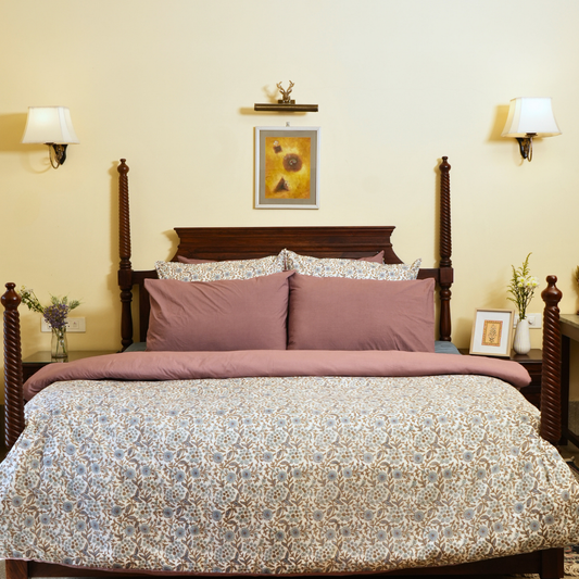 Bedroom with a wooden bed, floral bedding, and wall decor.