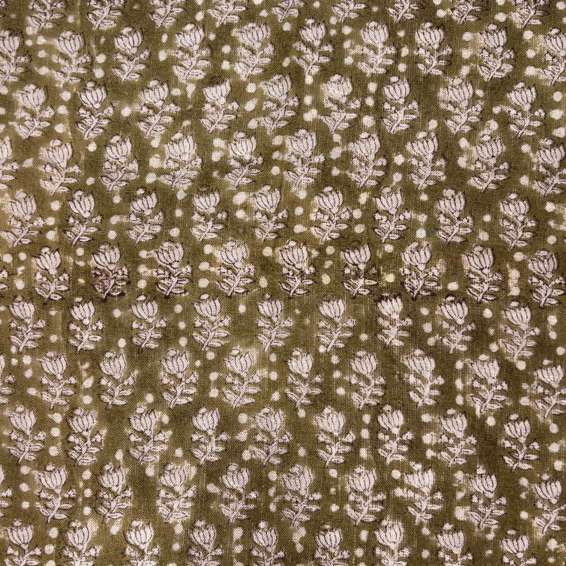 Patterned fabric with small floral design on a brown background