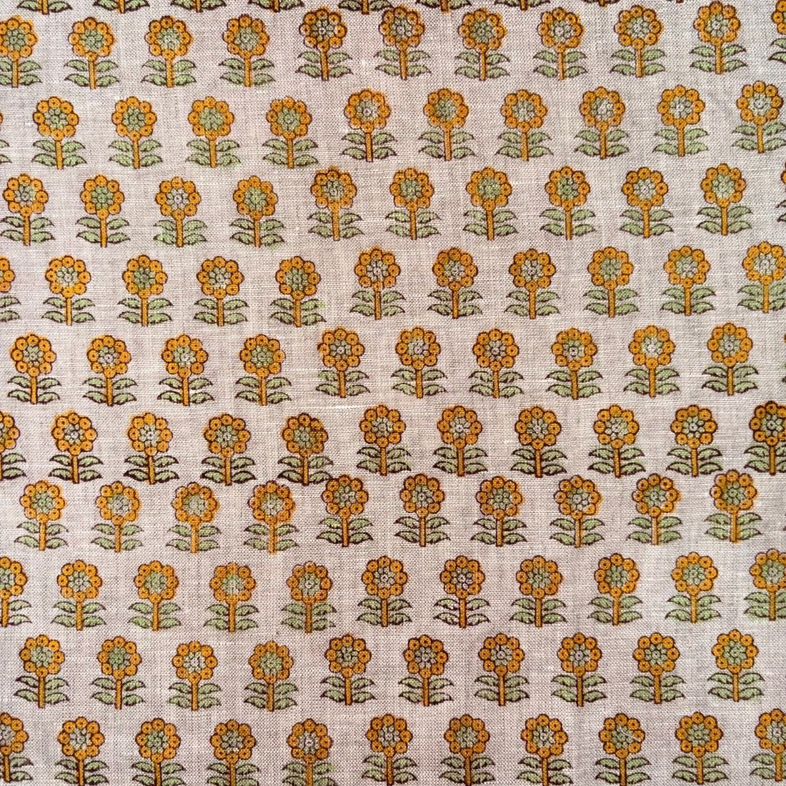 Patterned fabric with orange and green floral design on a grey background