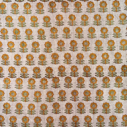 Patterned fabric with orange and green floral design on a grey background