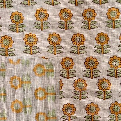 Floral patterned fabric with orange flowers on a grey background