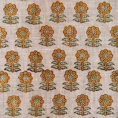 Pattern of orange flowers with green leaves on a grey background