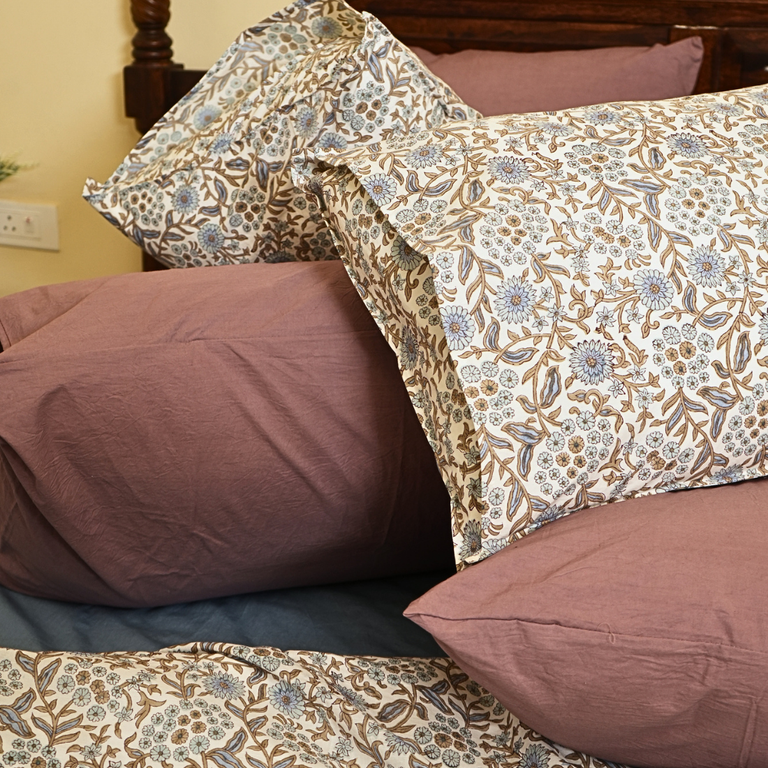 Floral patterned duvet and pillows on a bed with a neutral background