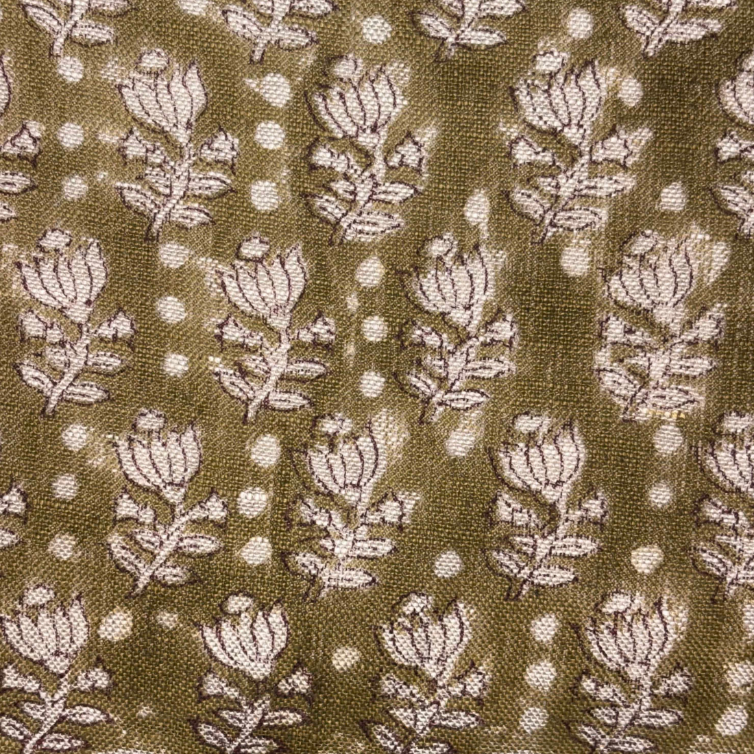 Floral patterned fabric with white flowers on a brown background