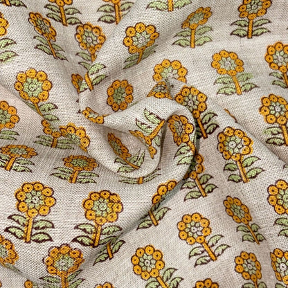 Floral patterned fabric with yellow and green flowers on a grey background