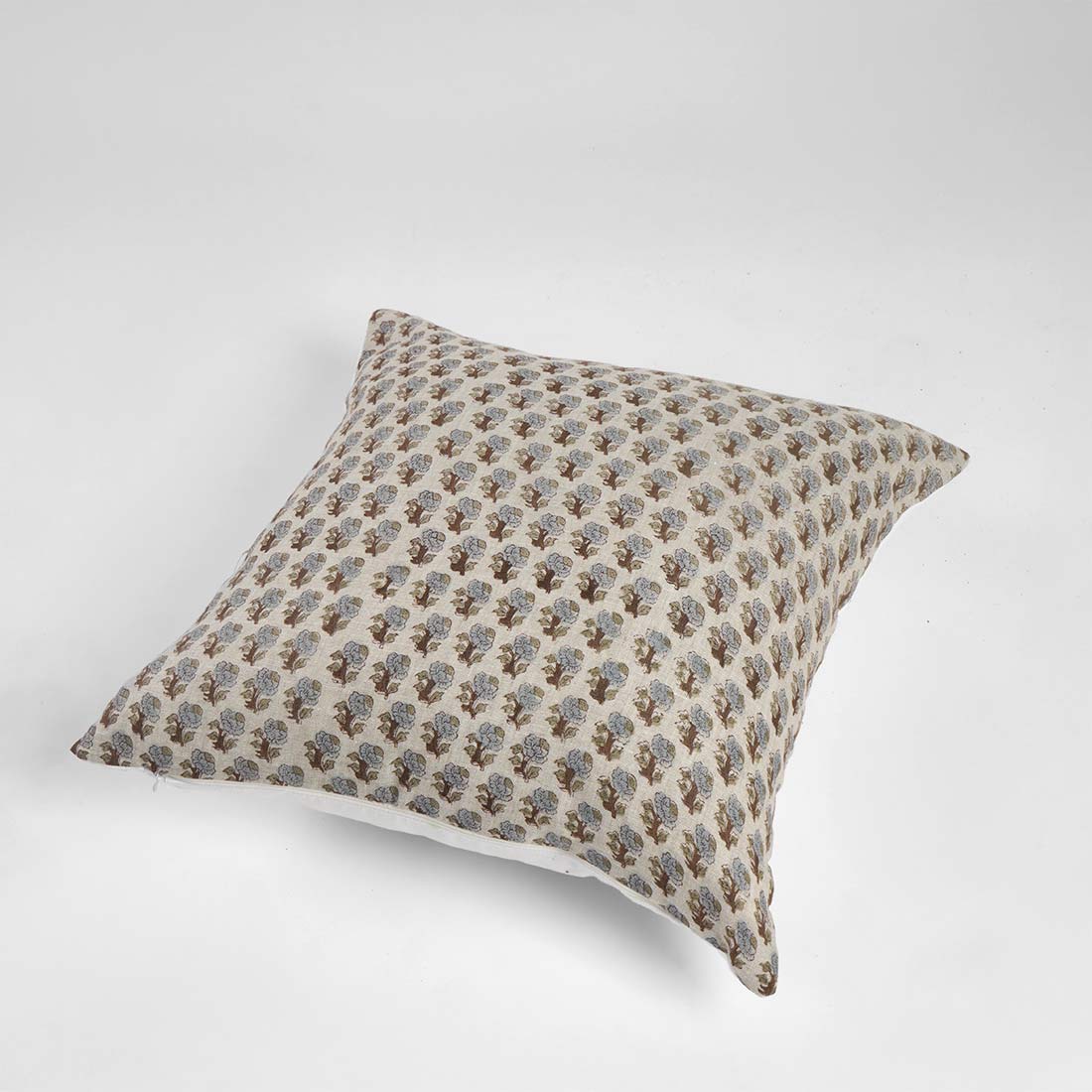 Decorative pillow with a subtle pattern on a white background
