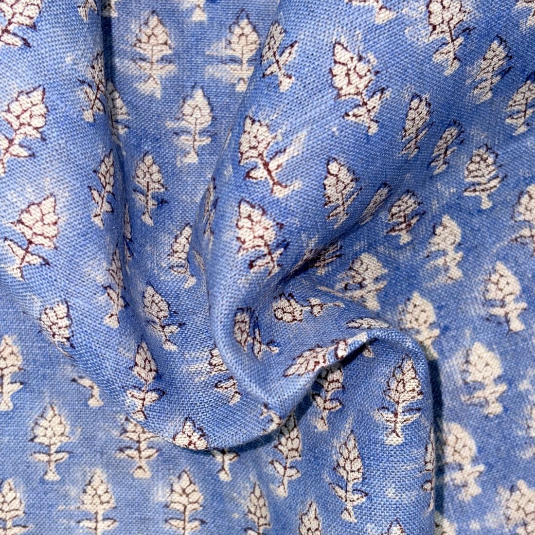 Close-up of blue fabric with white floral pattern