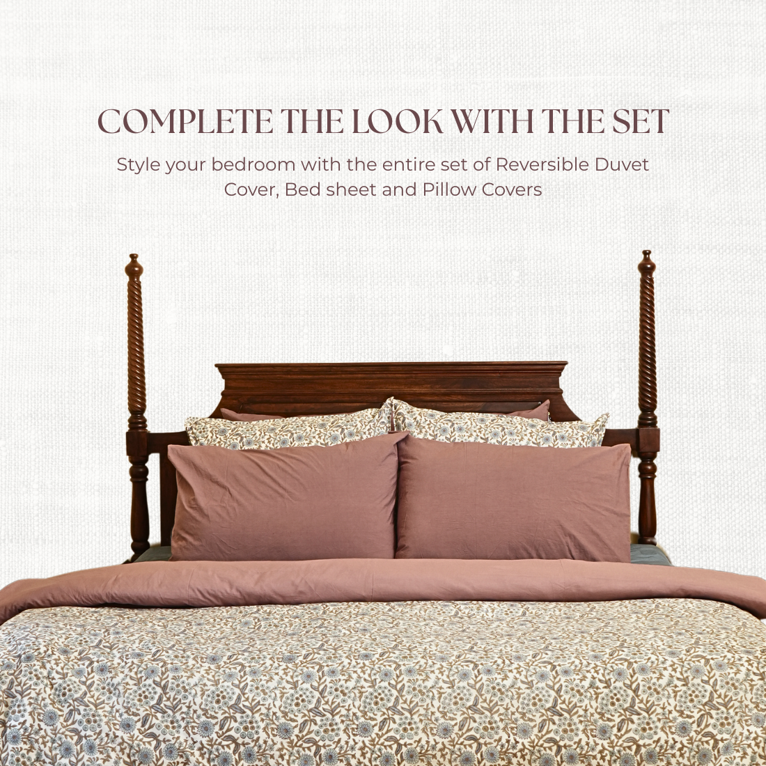 Bed with reversible duvet cover, bed sheet, and pillow covers on a white background