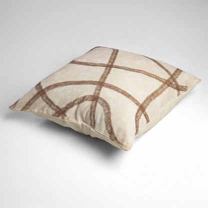 Beige pillow with brown abstract pattern on a light gray background