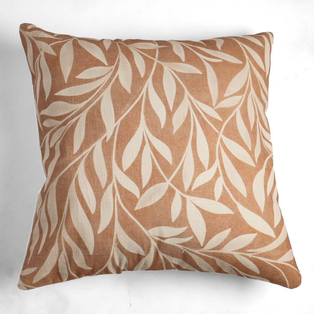 Decorative pillow with leaf pattern on a white background